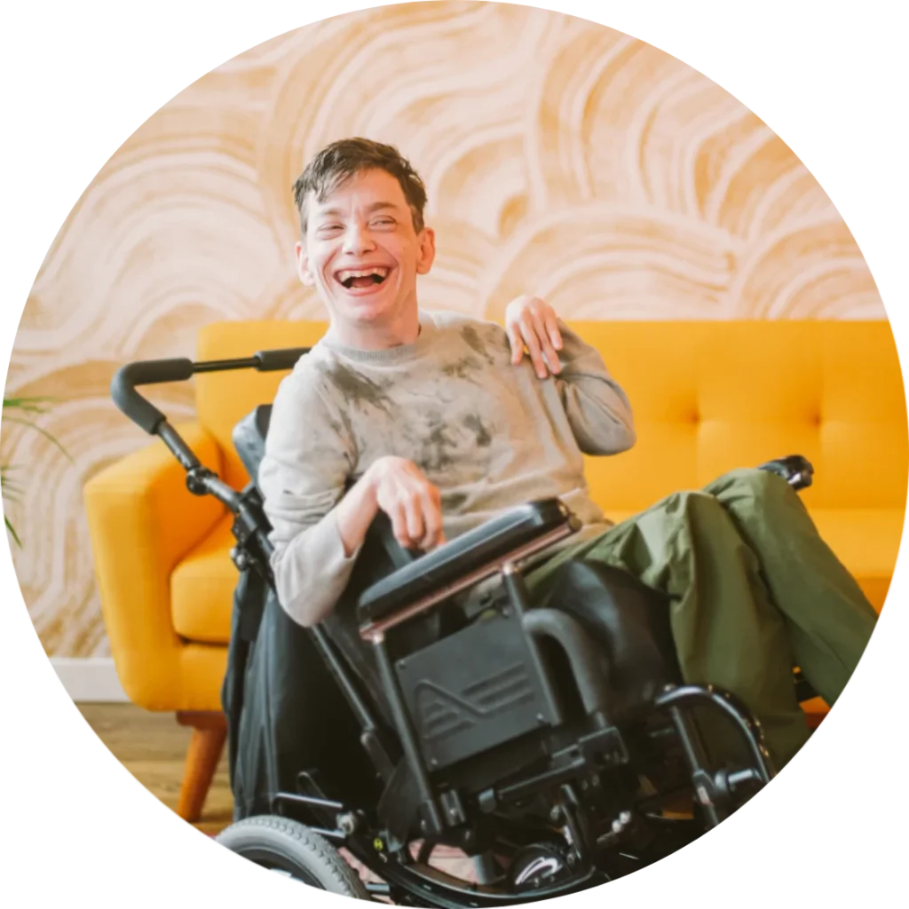 A disabled man sitting in his wheelchair smiling