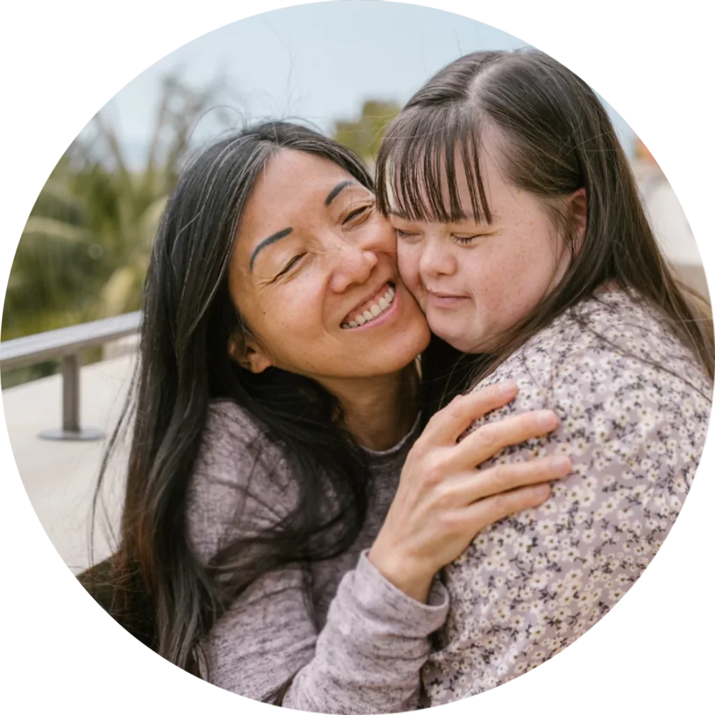 A disabled girl hugging her support worker